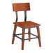 A Lancaster Table & Seating Industrial Chair with a wooden backrest and black metal frame.