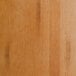 A close up of a Lancaster Table & Seating Industrial Backless Bar Stool with a honey maple finish.