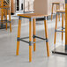 Lancaster Table & Seating backless bar stools with honey maple finish.