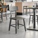 A Lancaster Table & Seating industrial chair with a table in a restaurant.