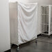 A white sheet on a Metro shelf cart.