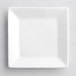 An Acopa bright white square porcelain plate on a white surface.