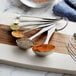 measuring spoons with different spices on a cutting board