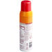 A Vegalene spray can of orange liquid with a label.