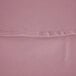 A close-up of a pink fabric with a hemmed edge.