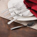 A white plate with a Walco Monterey salad fork on it.