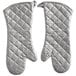 A pair of white oven mitts with silver quilted design.