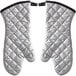 A pair of white oven mitts with silver quilted material.