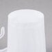 A close up of a Fineline white plastic coffee mug with a handle.