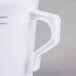 A close-up of a Fineline white plastic coffee mug with a handle.