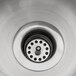 A stainless steel Regency dipper well bowl in a sink drain.