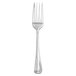 A silver Walco Imagination salad fork with a black top.