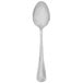 A silver Walco stainless steel teaspoon with a white handle.