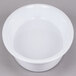 A white oval casserole dish with a round center.