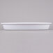 A white rectangular container on a gray surface.