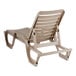 A taupe-colored adjustable resin chaise lounge chair with a slatted design and wheels on the back legs.