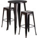 A Flash Furniture bar height table with black metal legs and a black and antique gold metal top with three square stools.