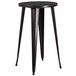 A Flash Furniture round black metal bar height table with legs.