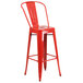 A red metal bar stool with a seat.