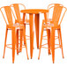 An orange Flash Furniture bar table surrounded by four orange stools.