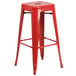 A red metal Flash Furniture square seat backless stool on a bar table.