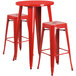 A red Flash Furniture bar table with two red square stools.