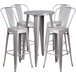 A Flash Furniture silver metal bar height table with 4 silver metal stools.