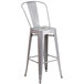 A silver metal bar stool with a backrest.