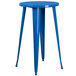 A blue round table with metal legs set with 4 blue metal backless stools.