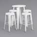 A white metal bar height table with a white square top and four white square seat backless stools.