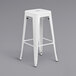 A white metal backless stool with a square seat.