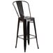 A Flash Furniture black metal bar stool with a round seat.