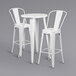 A Flash Furniture white metal bar height table with 2 white metal cafe stools.