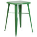 A green metal square table with two green metal stools.