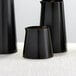 Three American Metalcraft black satin stainless steel creamers on a table.