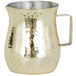 a gold pitcher with a handle