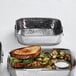 a sandwich with vegetables on a tray