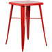 A red metal Flash Furniture bar height table with square legs and two red metal cafe stools.