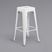 A Flash Furniture white metal bar height table with 2 square seat backless stools.