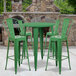 A Flash Furniture green metal table with four green stools with backrests.