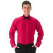 A man wearing a fuchsia Henry Segal tuxedo shirt with a black bow tie.