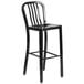 A black metal bar stool with a vertical slat backrest.