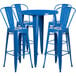 A blue table and chairs set with four stools.