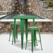 A green round bar height table with two green square seat stools.