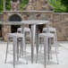 A Flash Furniture bar height table with square stools on an outdoor patio.