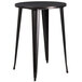 A Flash Furniture round black metal bar height table with legs.