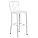 A white metal bar stool with a vertical slat back.