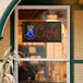 A rectangular LED cafe sign that says "coffee" in a window.