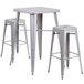 A Flash Furniture silver metal bar height table with 2 square backless stools.