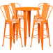 An orange metal Flash Furniture bar table with four orange stools.